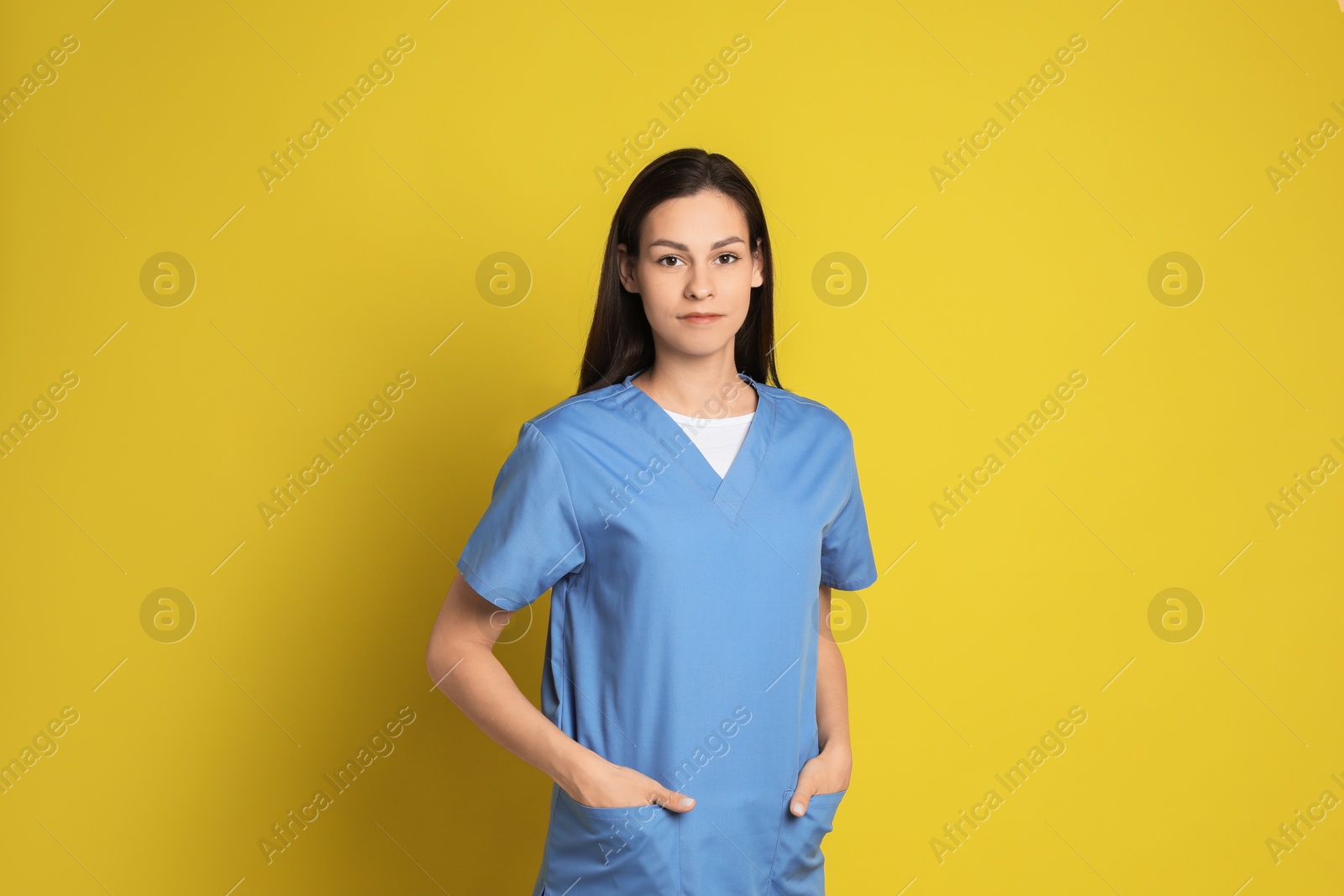 Photo of Portrait of beautiful nurse on yellow background