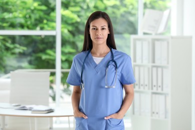 Beautiful nurse with stethoscope in hospital office