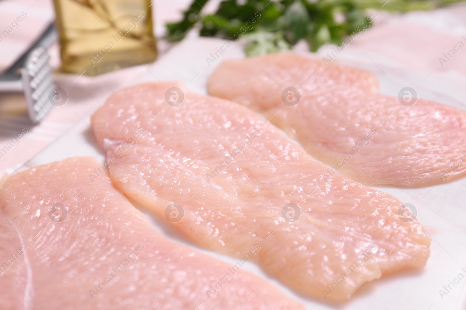 Photo of Making schnitzel. Raw meat chops on light table, closeup