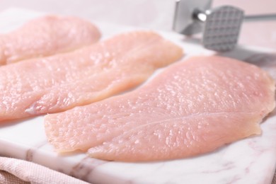 Making schnitzel. Raw meat chops on light table, closeup