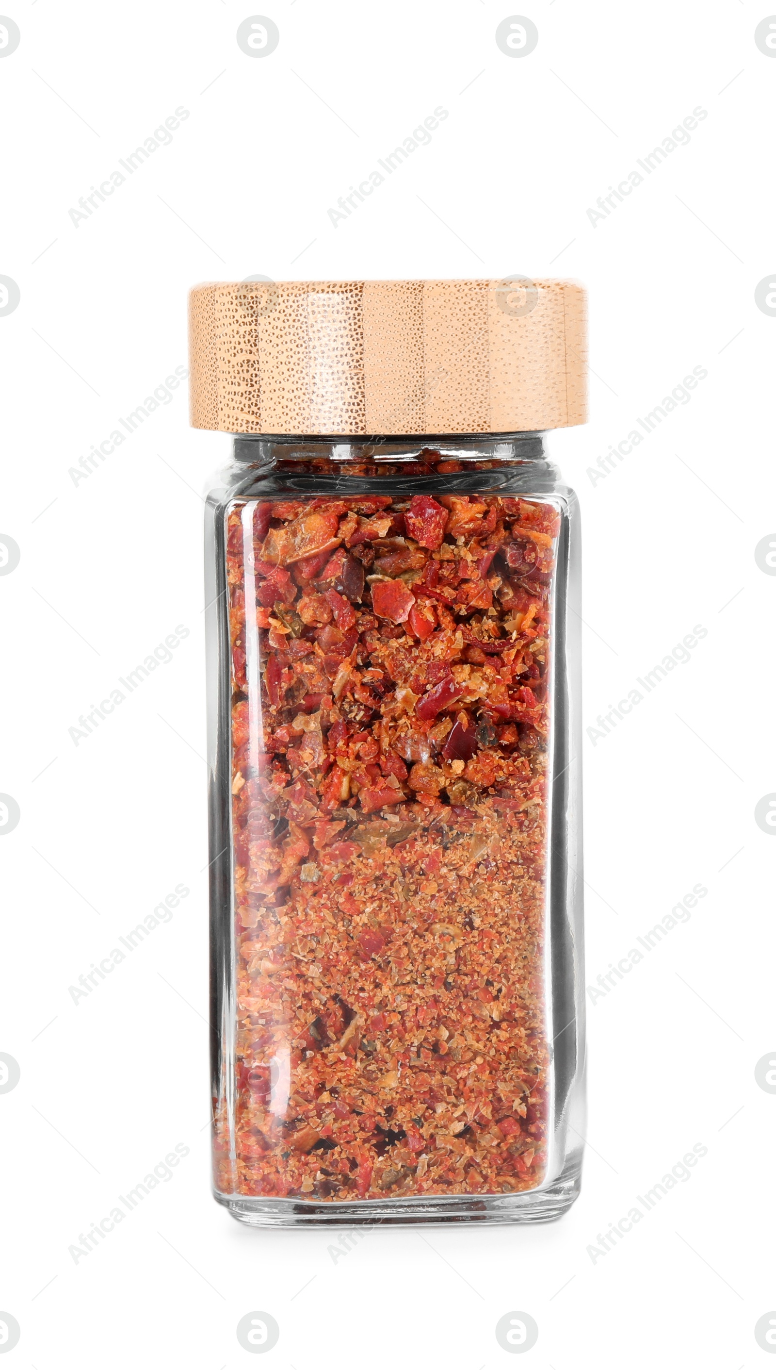 Photo of Red chili pepper flakes in glass jar isolated on white