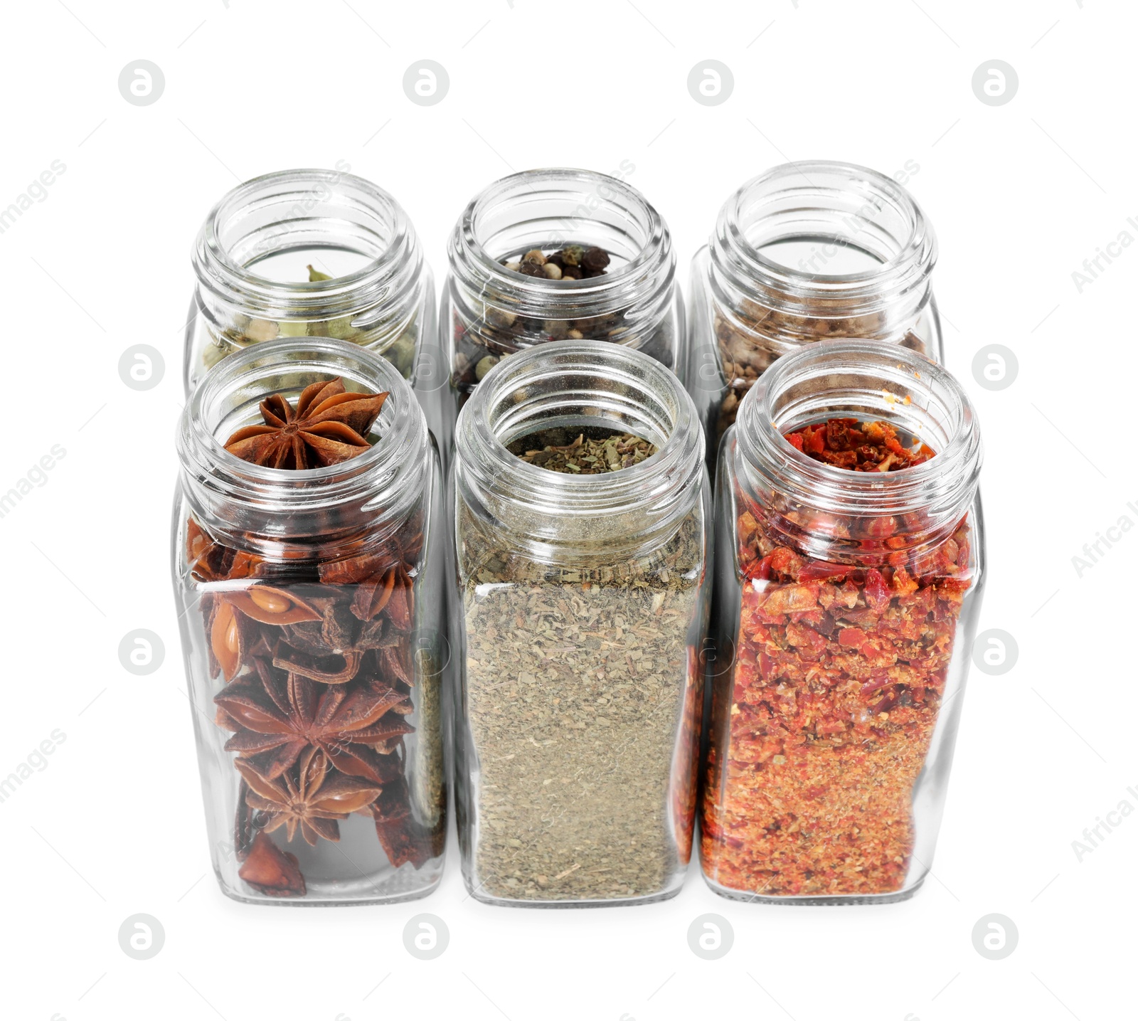 Photo of Different spices in glass jars isolated on white