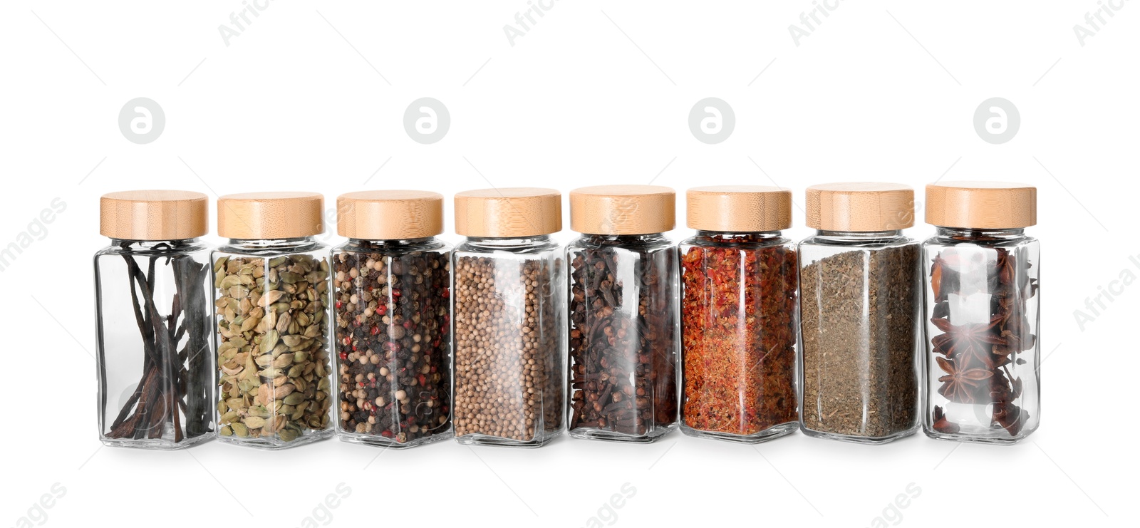 Photo of Different spices in glass jars isolated on white