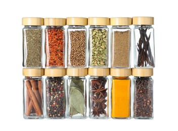 Photo of Different spices in glass jars isolated on white