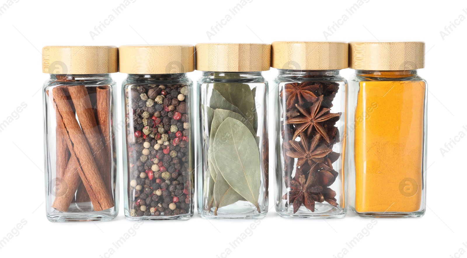 Photo of Different spices in glass jars isolated on white