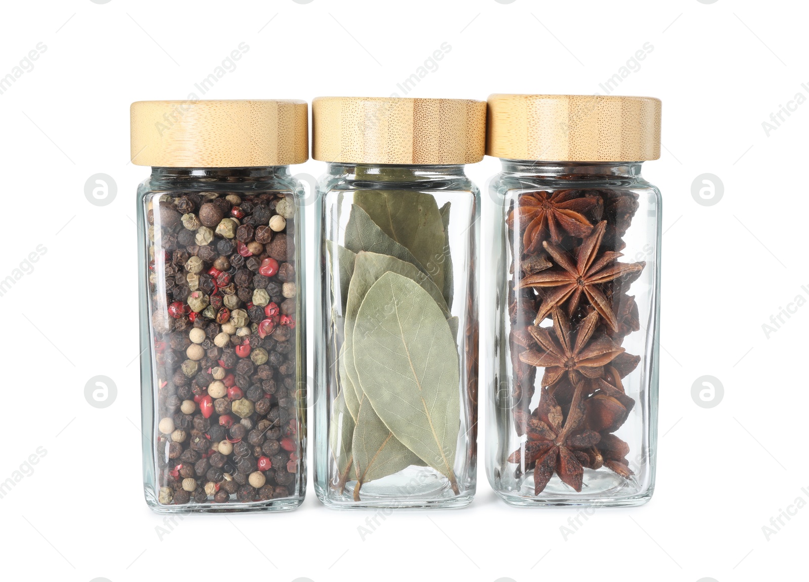 Photo of Different spices in glass jars isolated on white