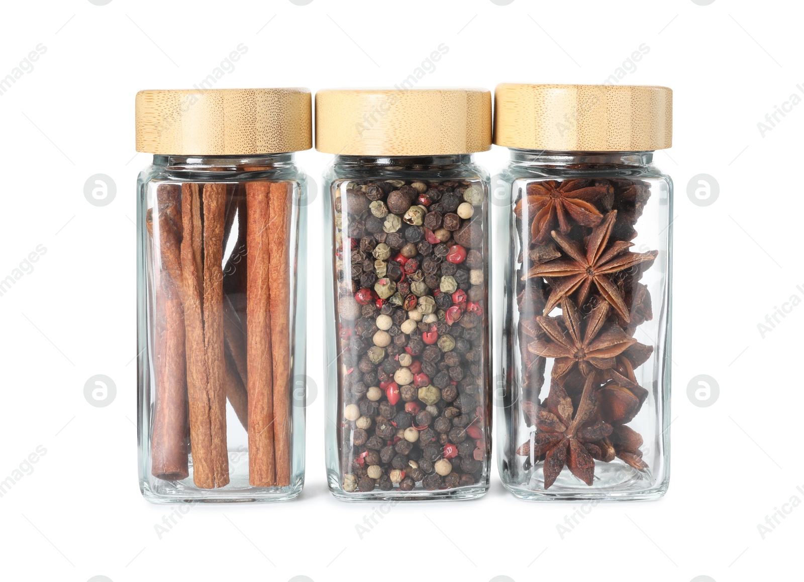 Photo of Different spices in glass jars isolated on white