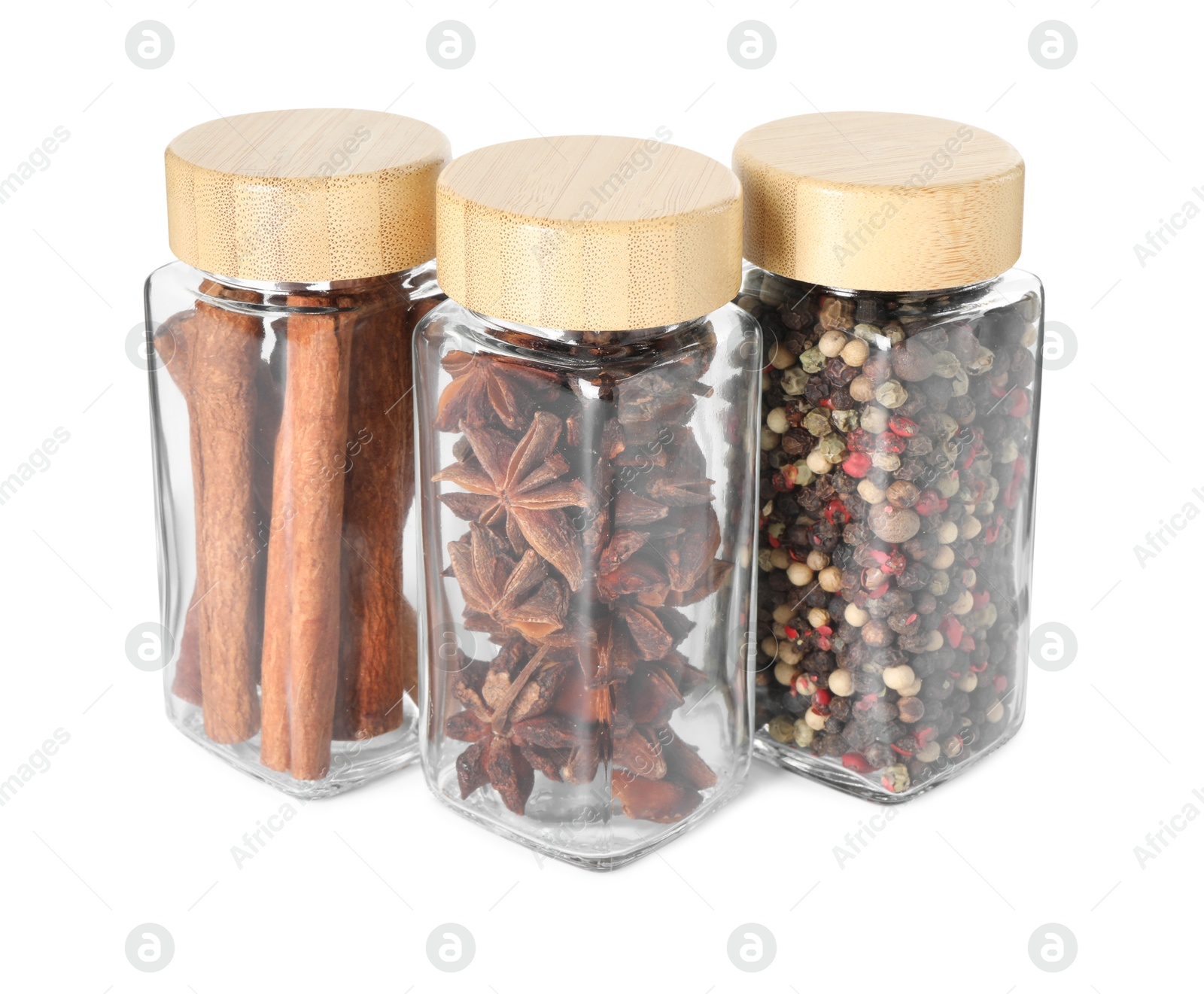 Photo of Different spices in glass jars isolated on white