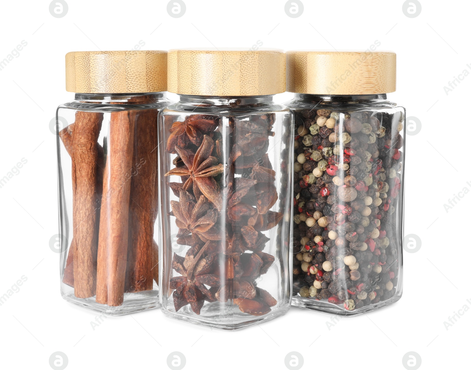 Photo of Different spices in glass jars isolated on white