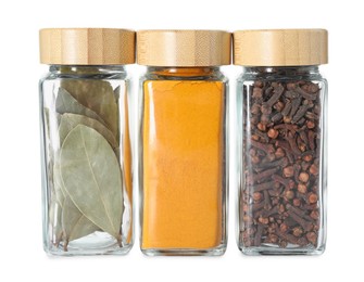 Different spices in glass jars isolated on white