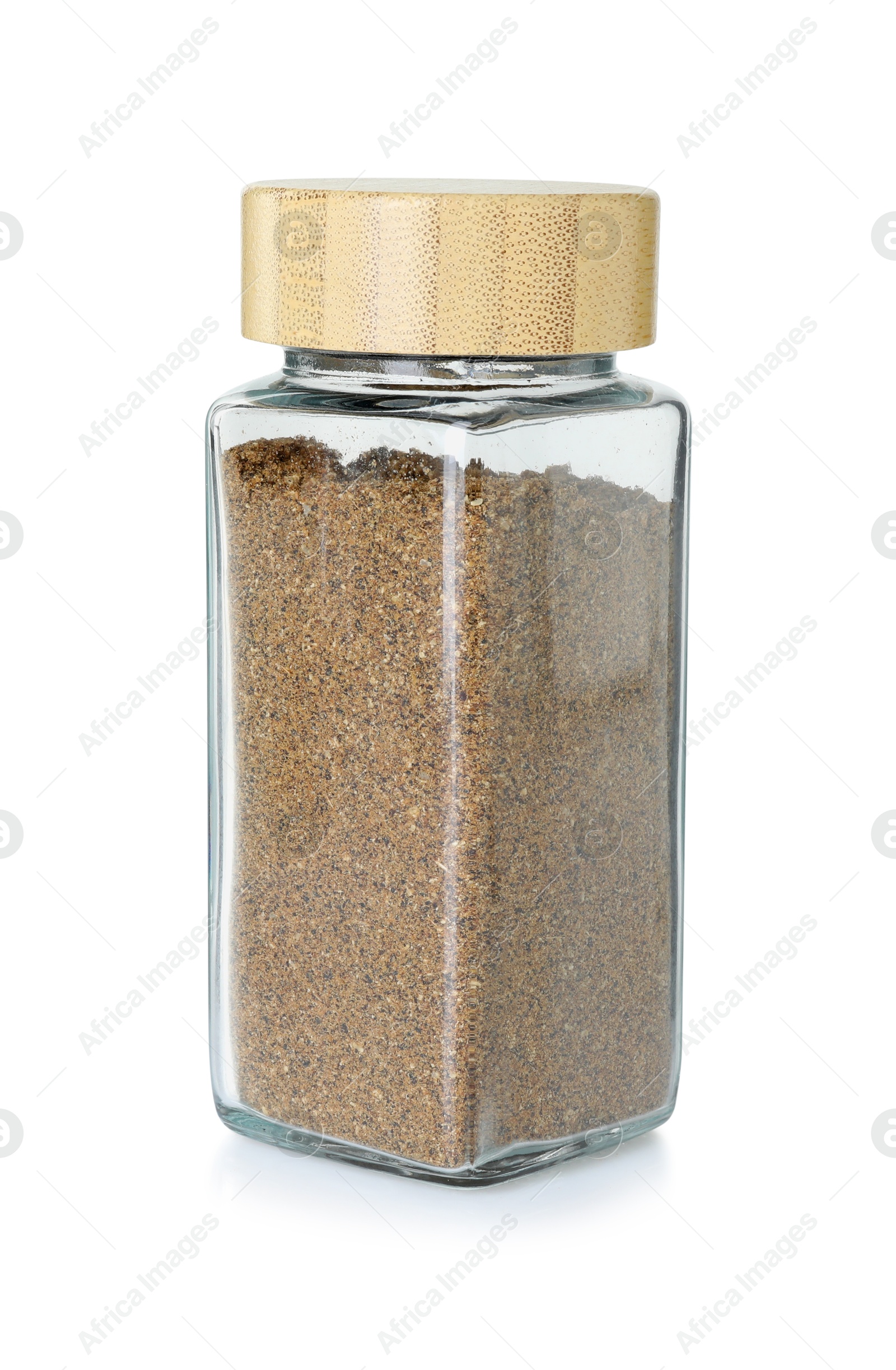 Photo of Cumin powder in glass jar isolated on white