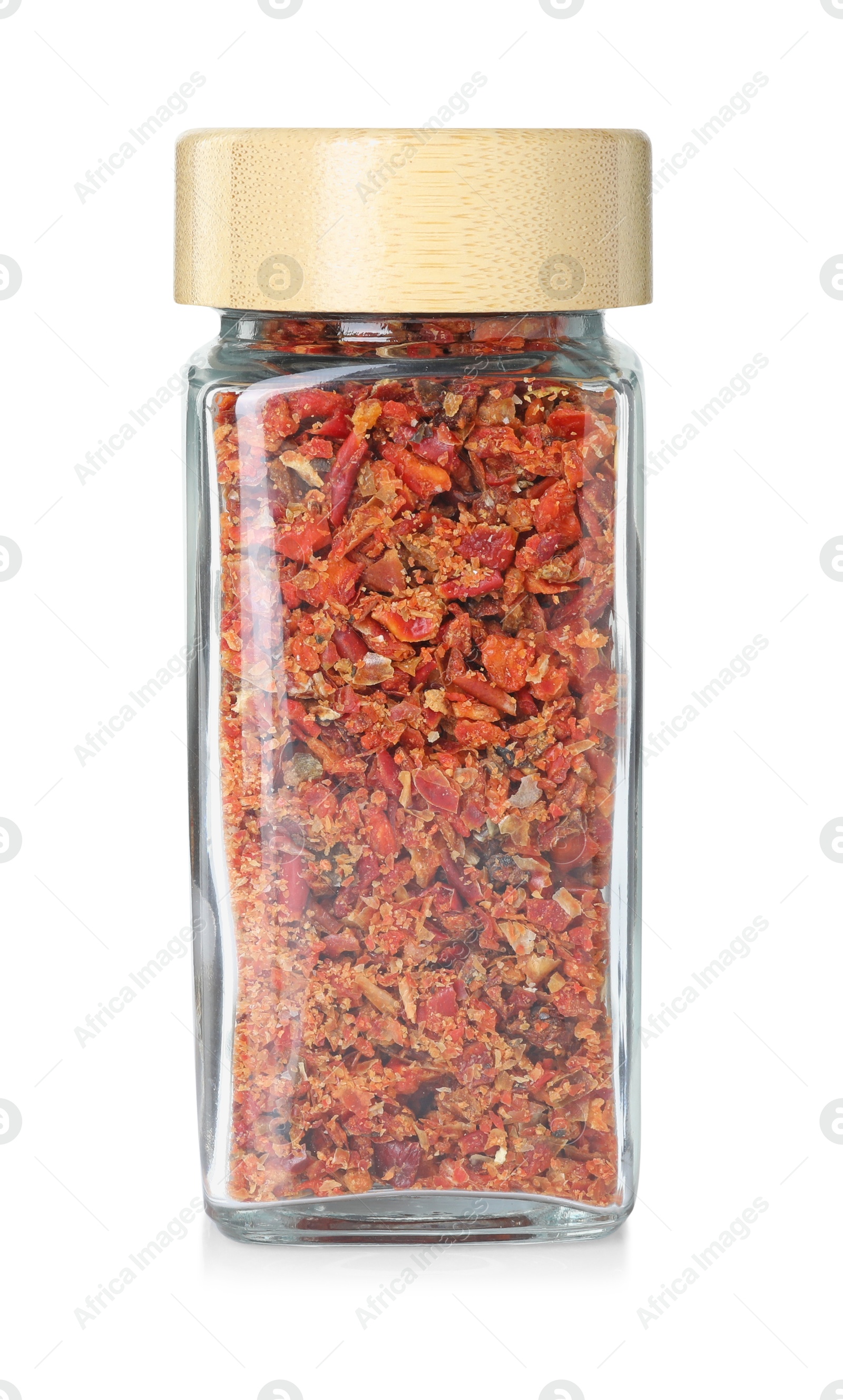 Photo of Red chili pepper flakes in glass jar isolated on white