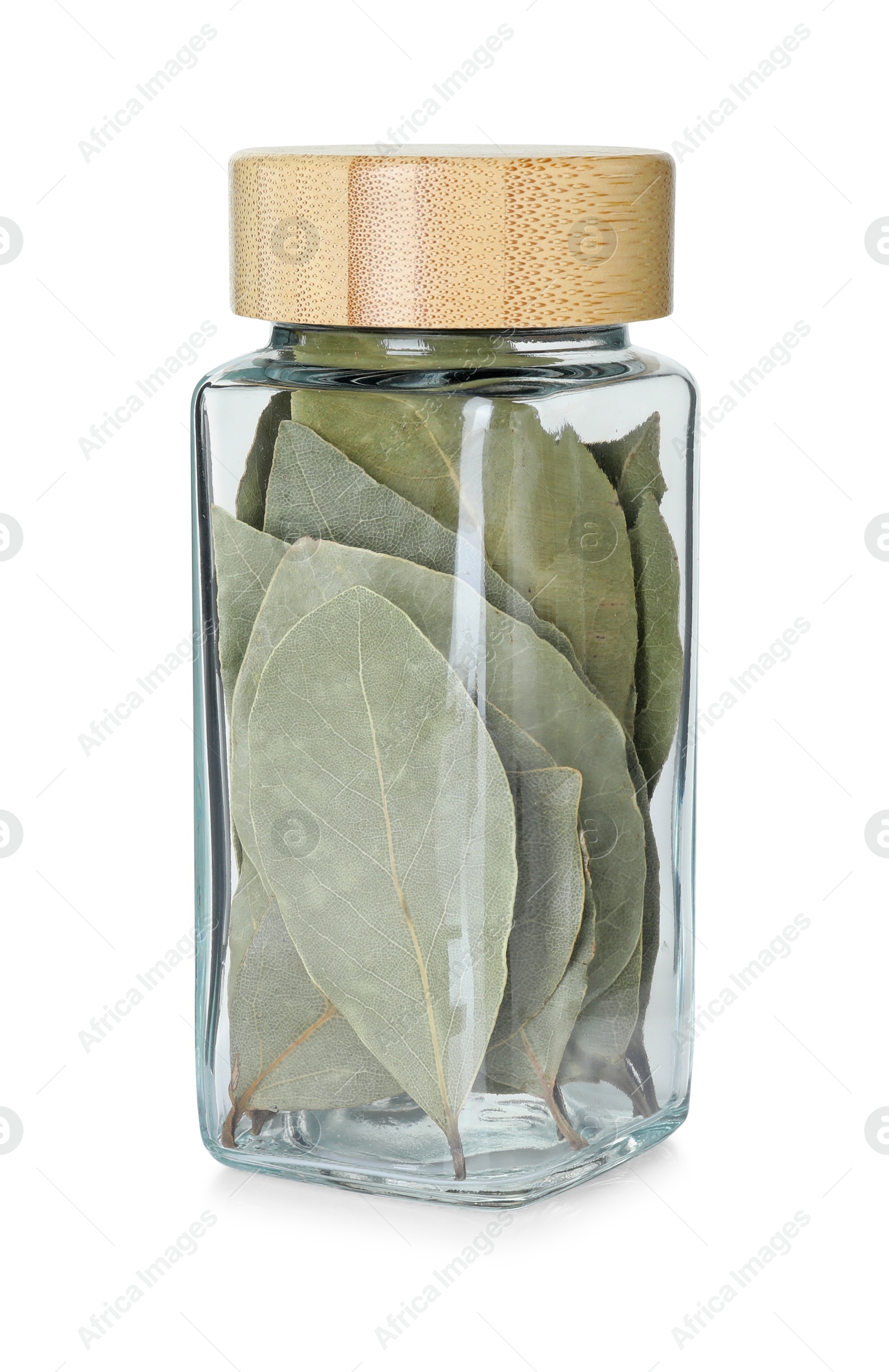 Photo of Dry bay leaves in glass jar isolated on white