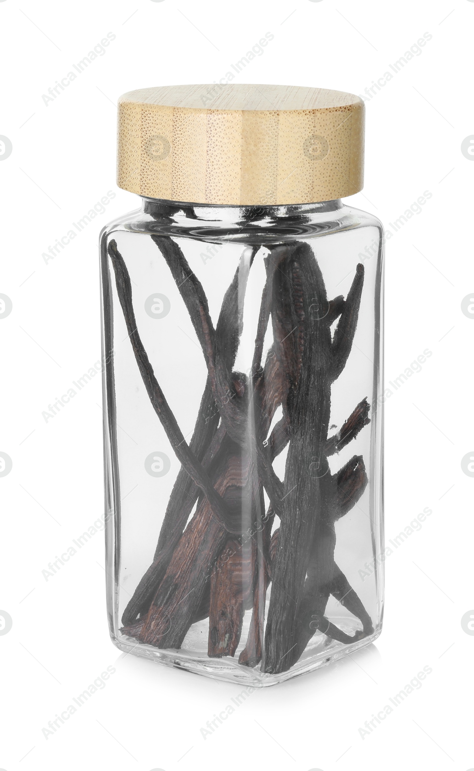 Photo of Vanilla pods in glass jar isolated on white