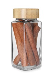 Photo of Cinnamon sticks in glass jar isolated on white