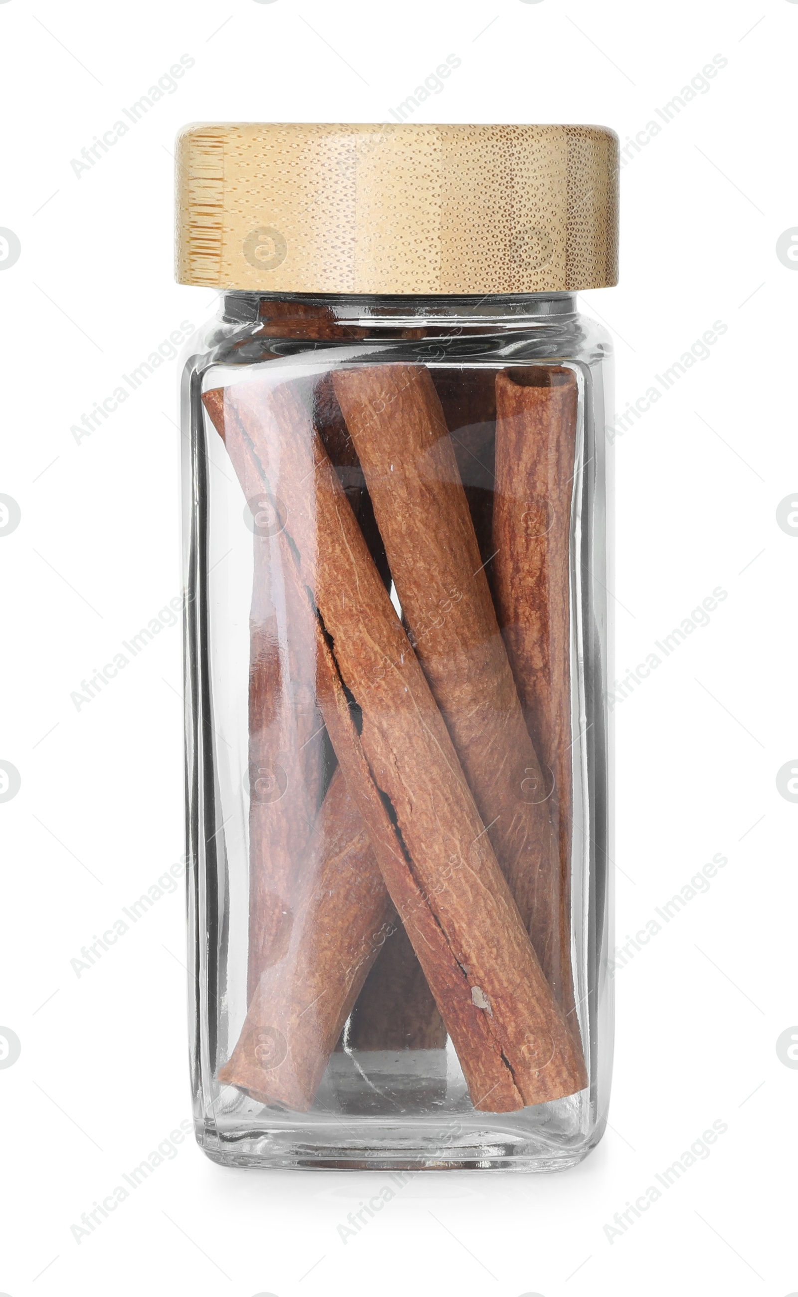 Photo of Cinnamon sticks in glass jar isolated on white