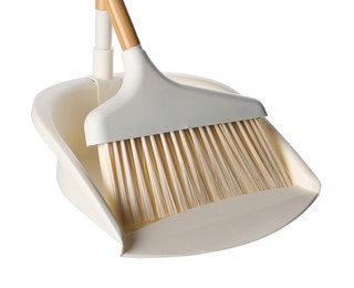 Photo of Broom and dustpan isolated on white. Cleaning tools