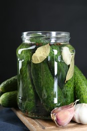 Photo of Making pickles. Fresh cucumbers and spices in jar on table, closeup