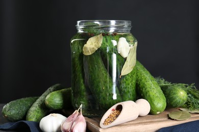 Photo of Making pickles. Fresh cucumbers and spices in jar on table, closeup