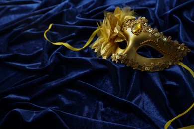 One beautiful carnival mask on blue fabric. Space for text