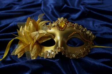 One beautiful carnival mask on blue fabric