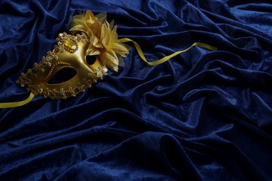 One beautiful carnival mask on blue fabric. Space for text