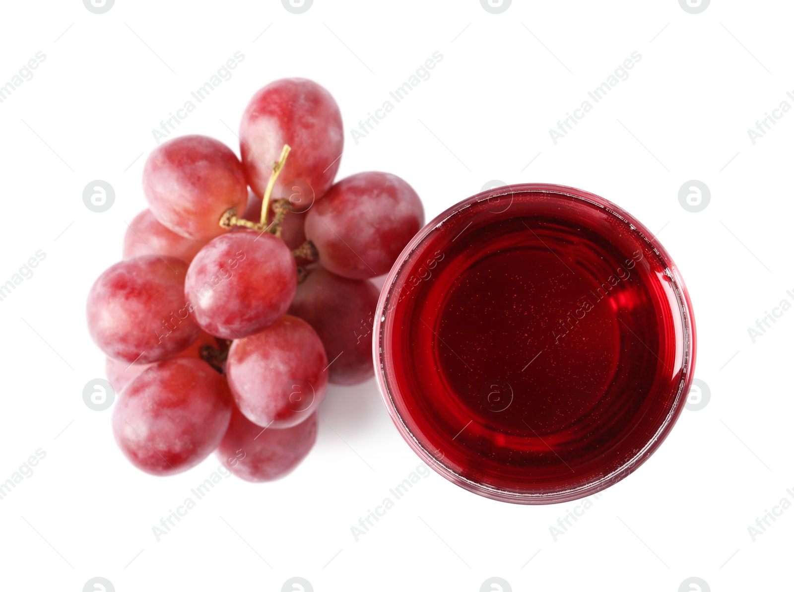 Photo of Ripe grapes and glass of tasty juice isolated on white, top view