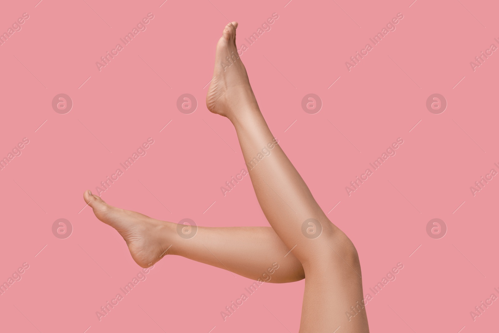 Photo of Woman with smooth legs on pink background, closeup