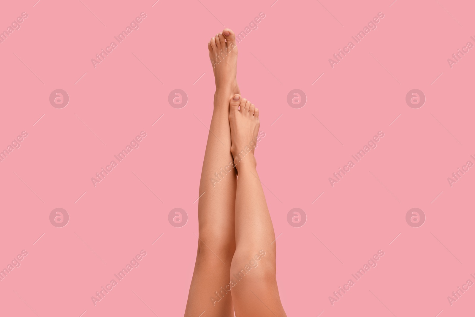 Photo of Woman with smooth legs on pink background, closeup