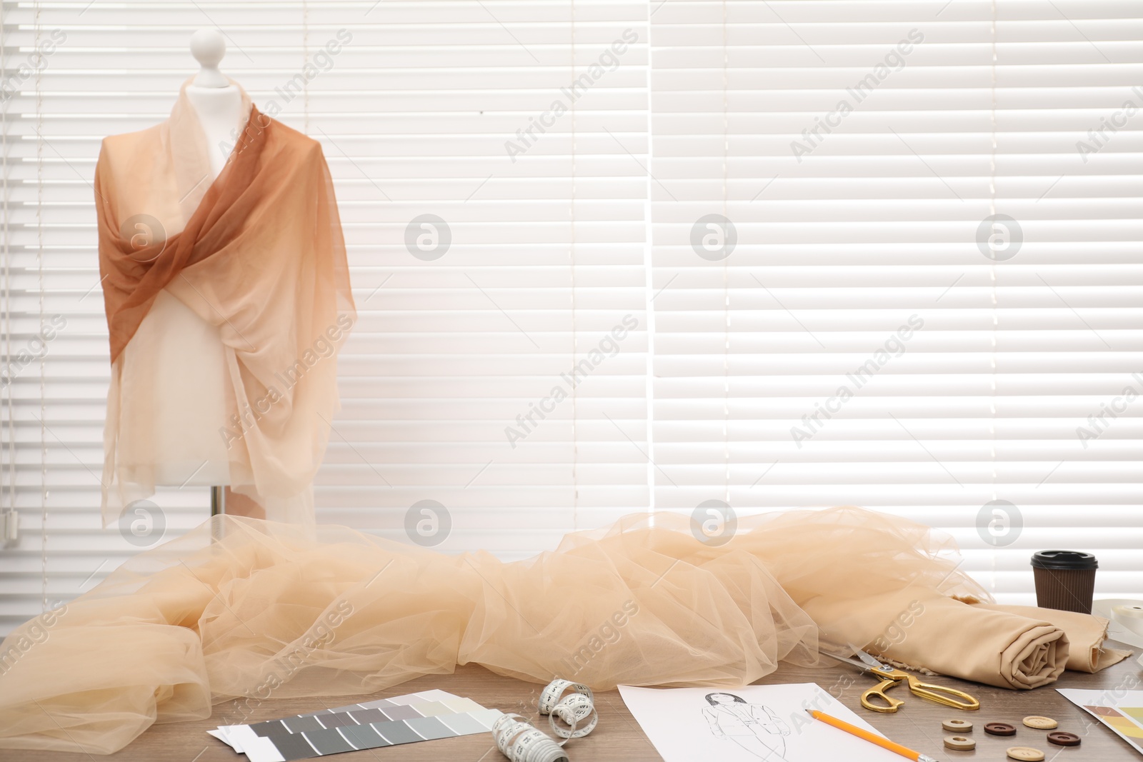 Photo of Fashion designer`s workplace with fabric samples and sewing supplies