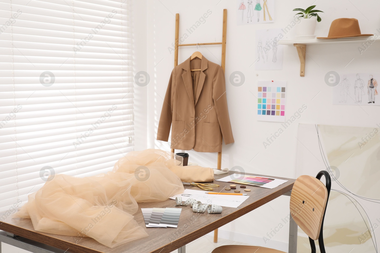 Photo of Fashion designer`s workplace with fabric samples and sewing supplies