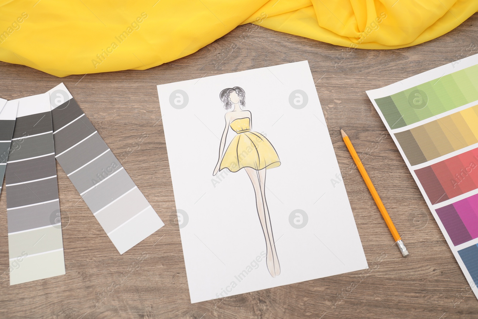 Photo of Sketch of stylish clothes, color palette and other fashion designer`s supplies on wooden table