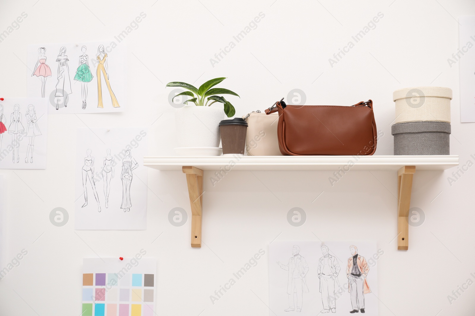 Photo of Sketches of clothes and accessories supplies in fashion designer`s workshop