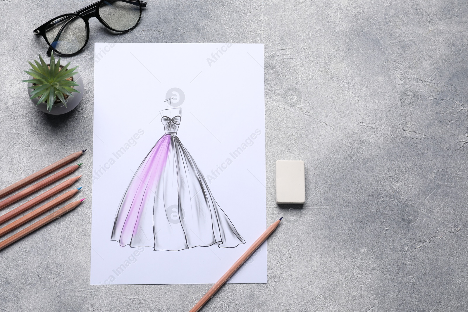 Photo of Sketch of stylish clothes and other fashion designer`s supplies on grey table, flat lay. Space for text