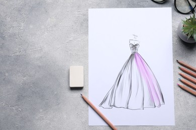 Photo of Sketch of stylish clothes and other fashion designer`s supplies on grey table, flat lay. Space for text