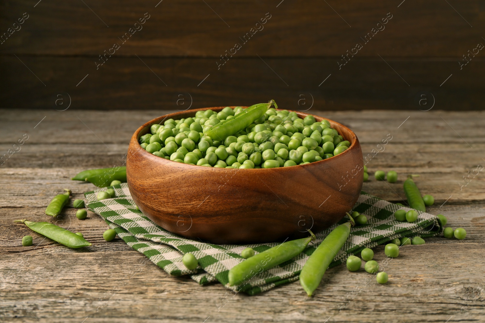 Photo of Fresh green peas and pods on wooden table