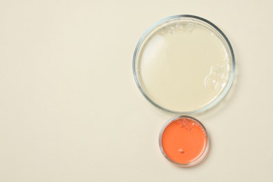 Photo of Petri dishes with samples on beige background, top view. Space for text