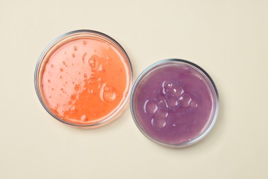 Petri dishes with samples on beige background, top view