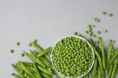 Photo of Fresh green peas and pods on grey table, flat lay. Space for text