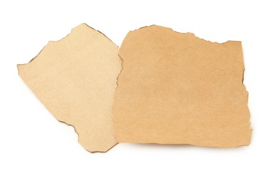 Photo of Pieces of old paper with dark burnt borders isolated on white