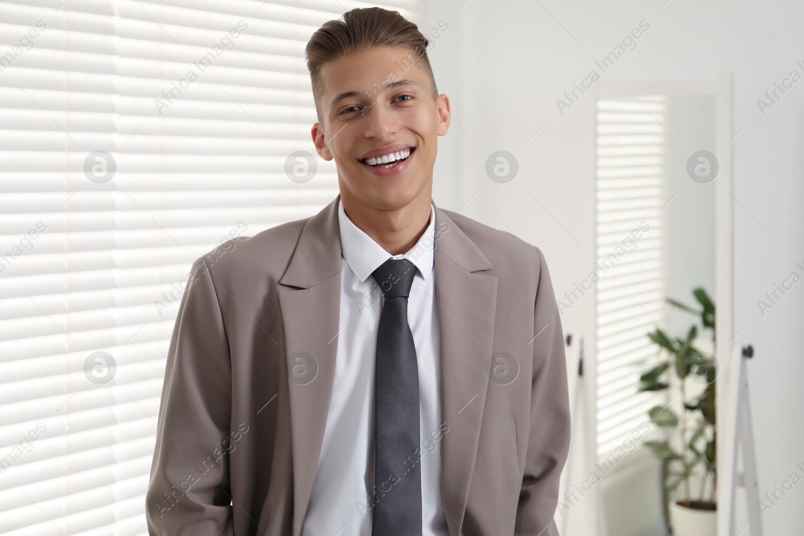 Photo of Handsome man in stylish suit at home