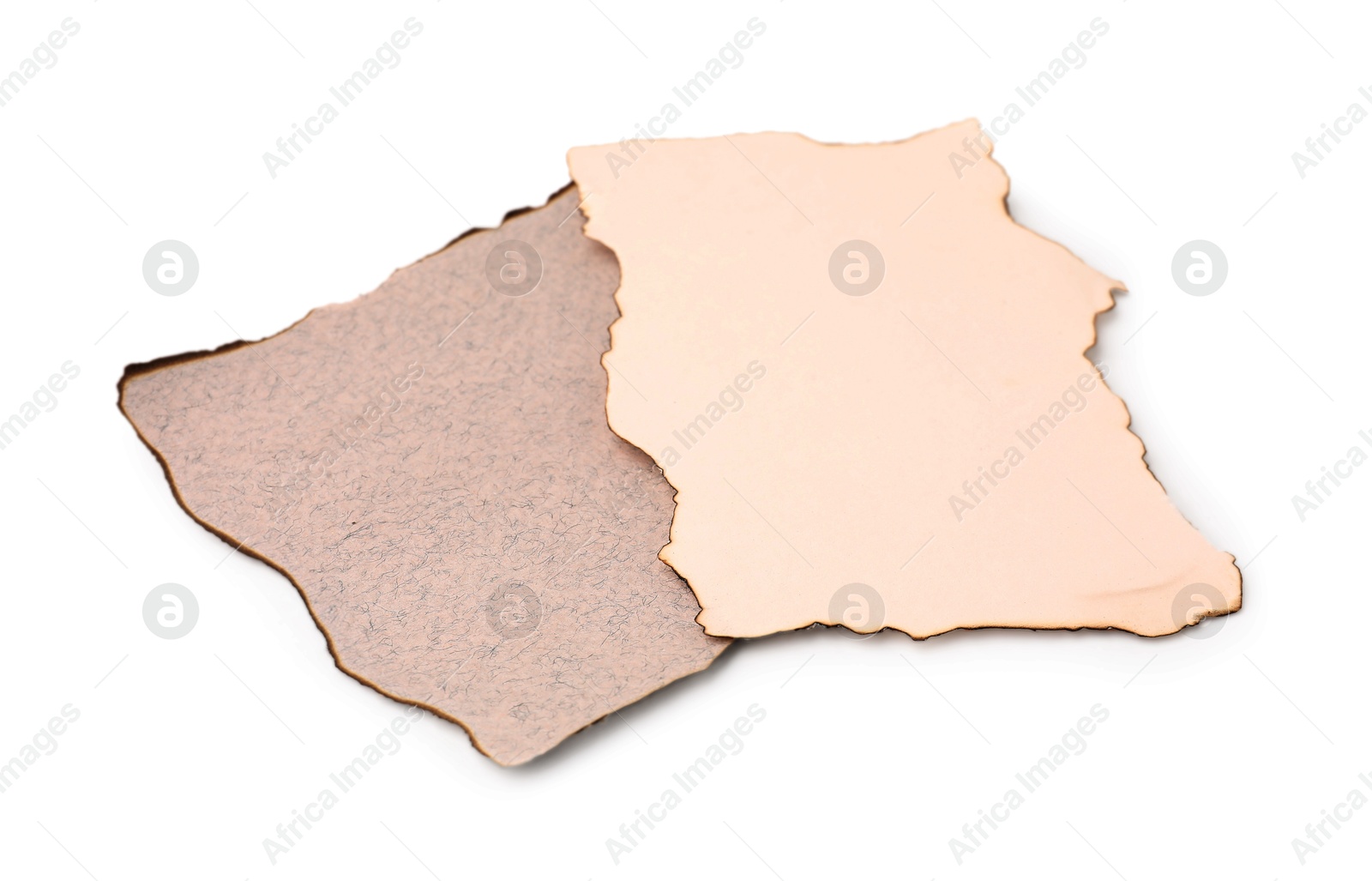 Photo of Pieces of old paper with dark burnt borders isolated on white