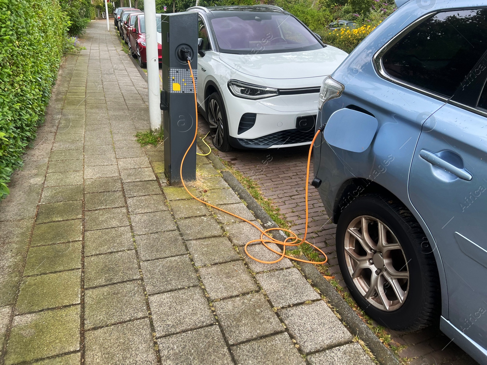 Photo of Modern electric car charging on city street