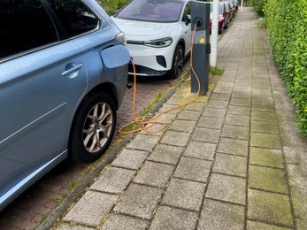 Modern electric car charging on city street