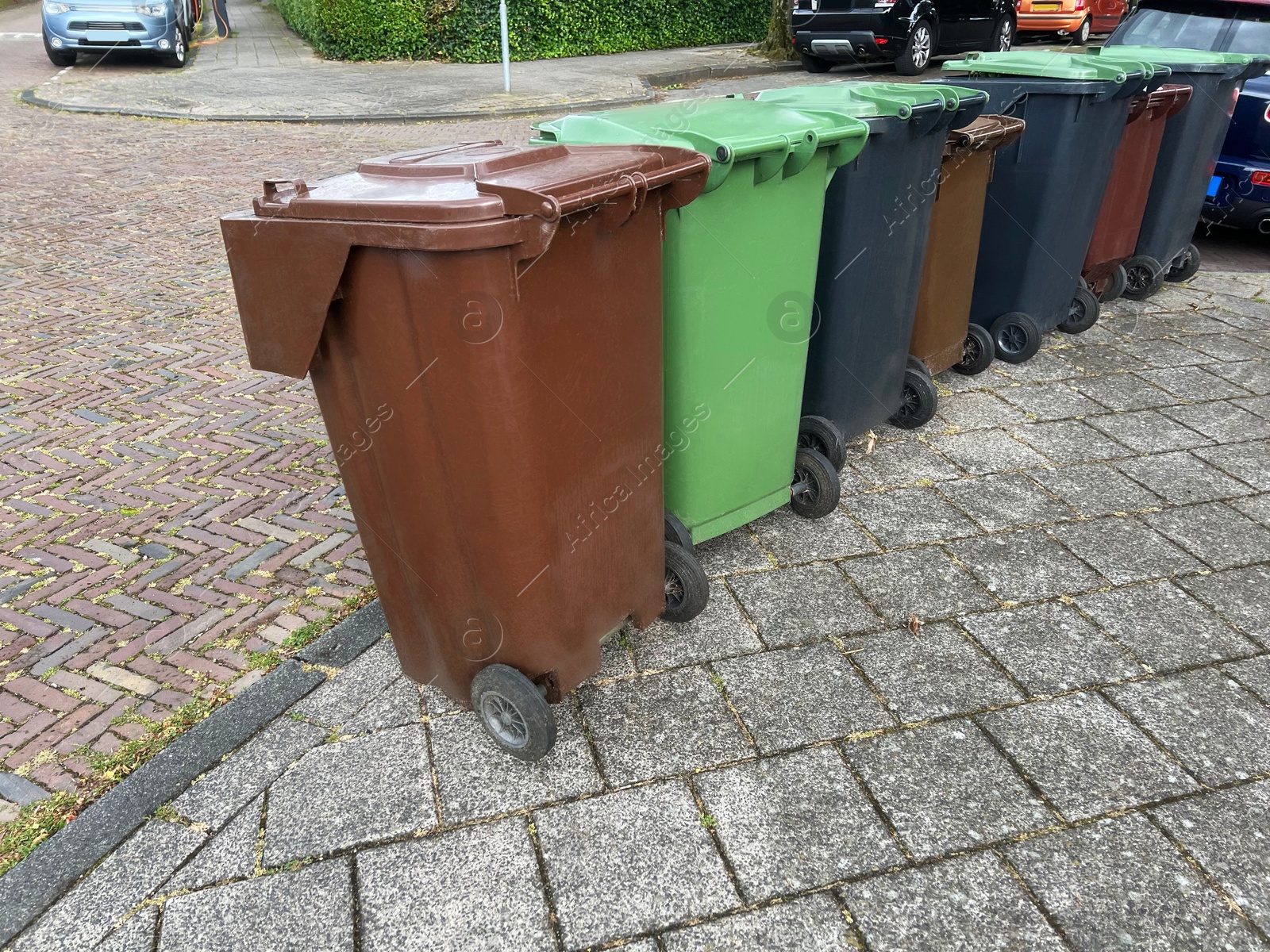 Photo of Many color trash bins on city street