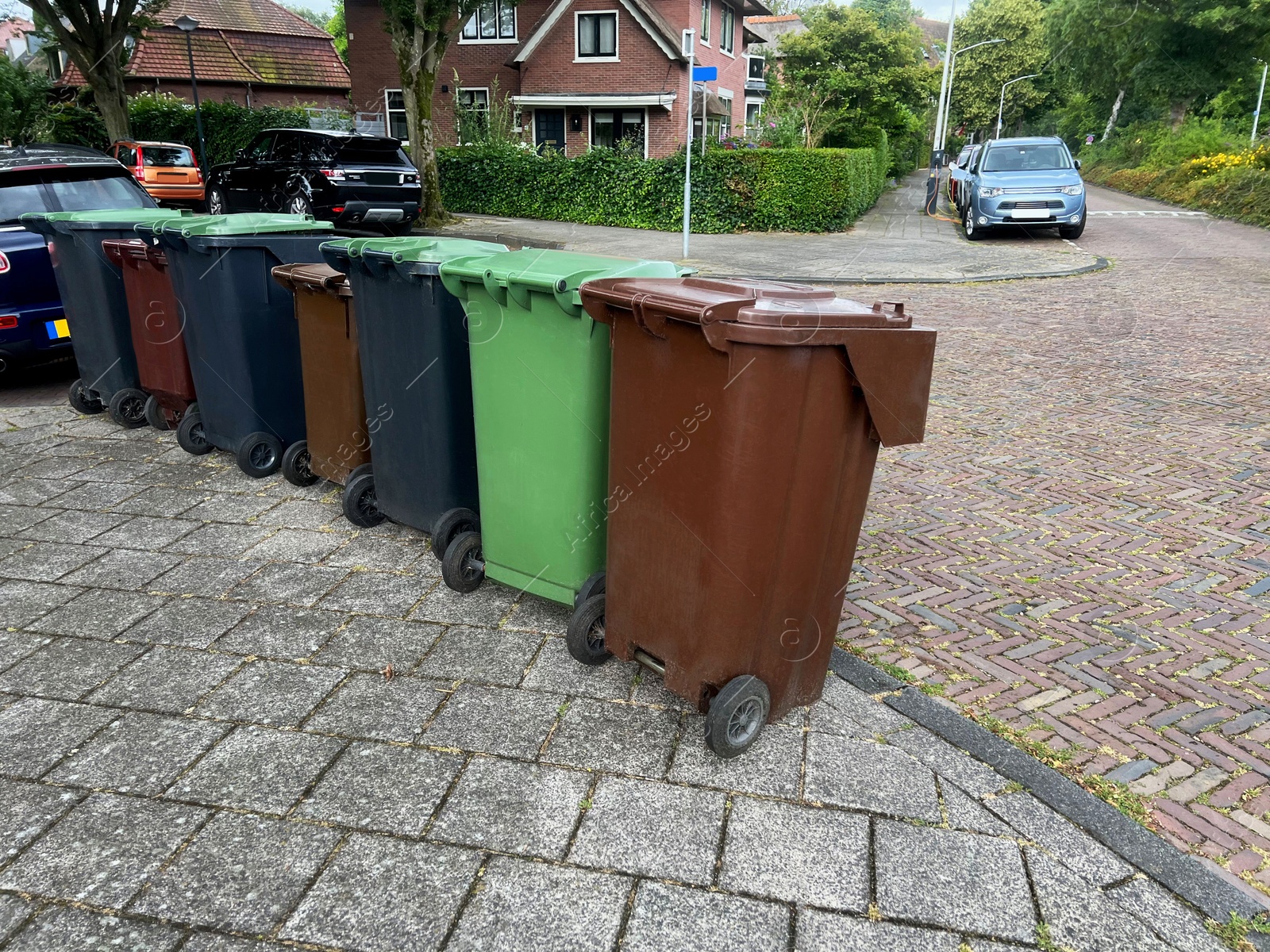 Photo of Many color trash bins on city street