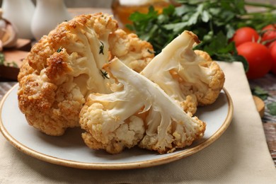 Plate with tasty baked cauliflower on table, closeup