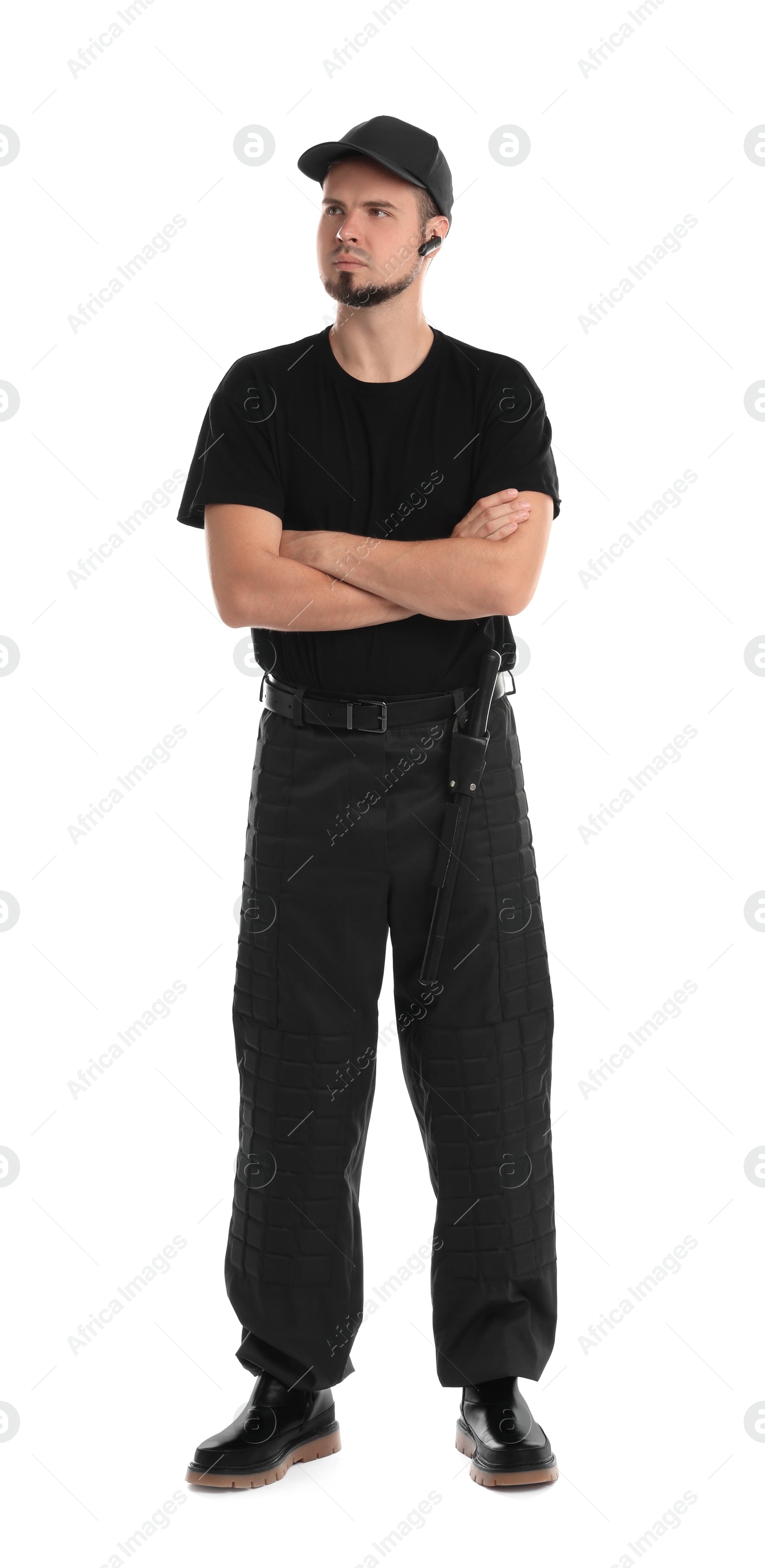 Photo of Young bodyguard with baton and earpiece isolated on white