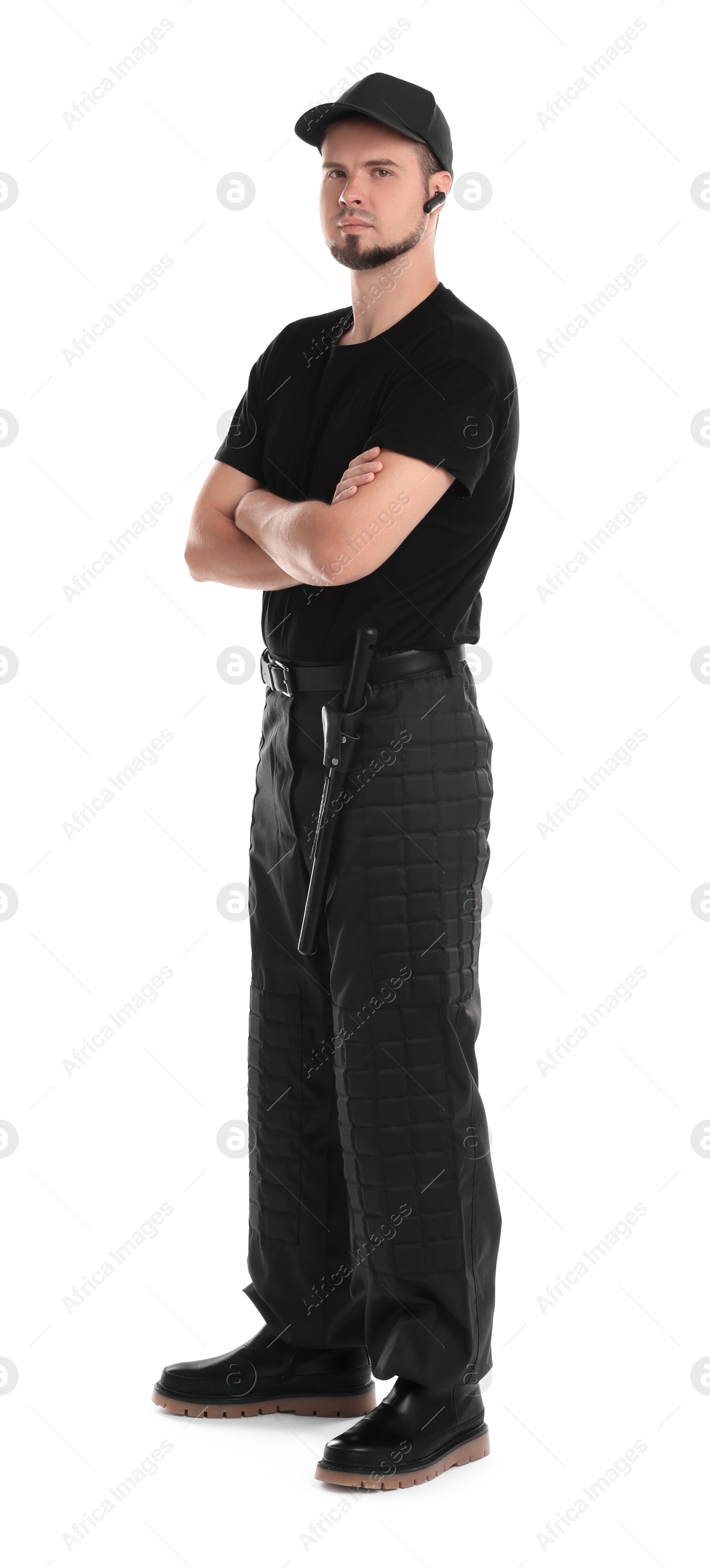 Photo of Young bodyguard with baton and earpiece isolated on white