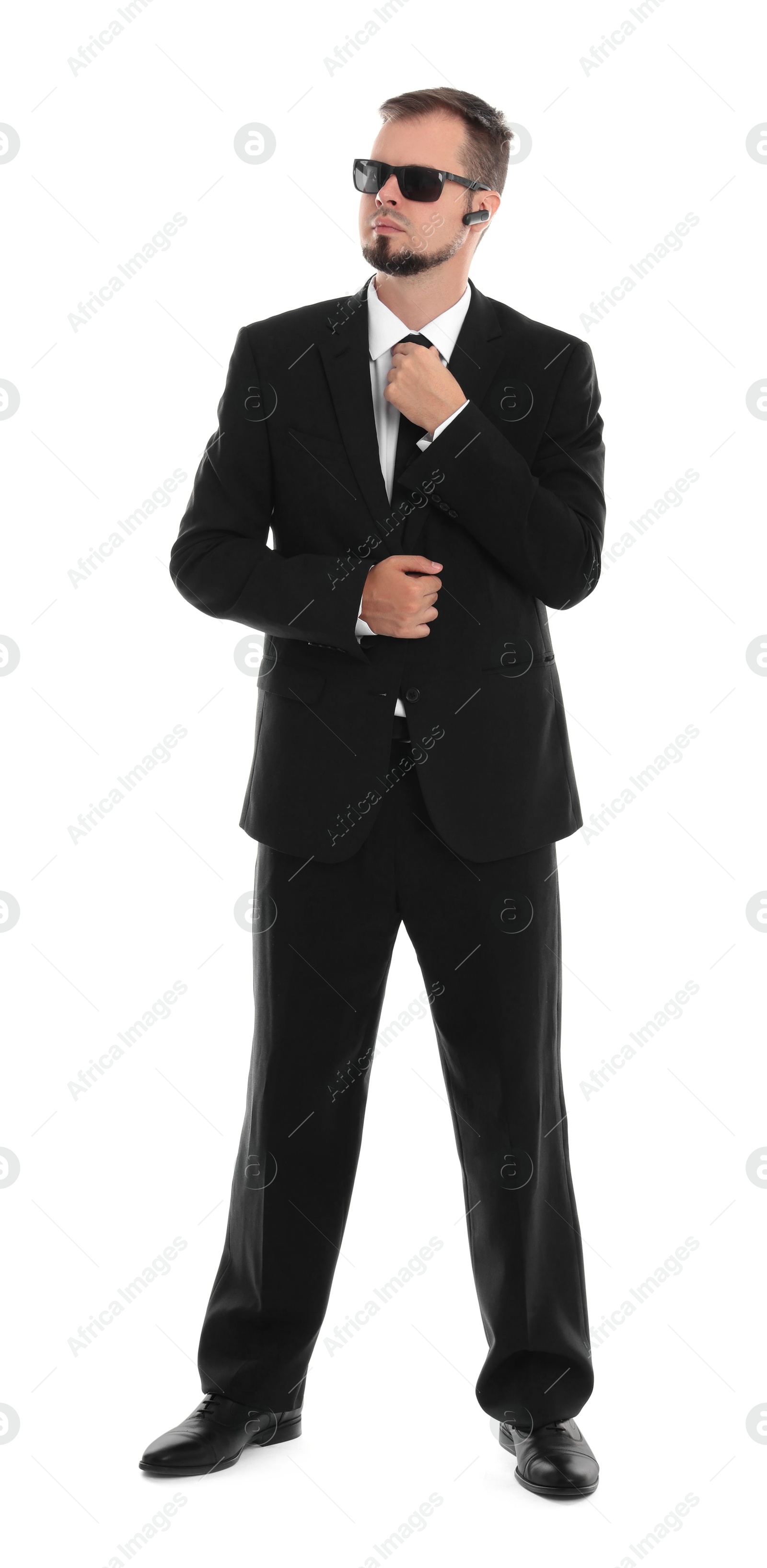 Photo of Young bodyguard in suit and sunglasses isolated on white